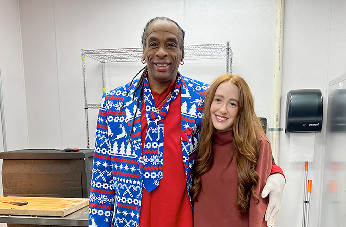 Woman taking a picture with a man in a festive suit for the holiday brunch