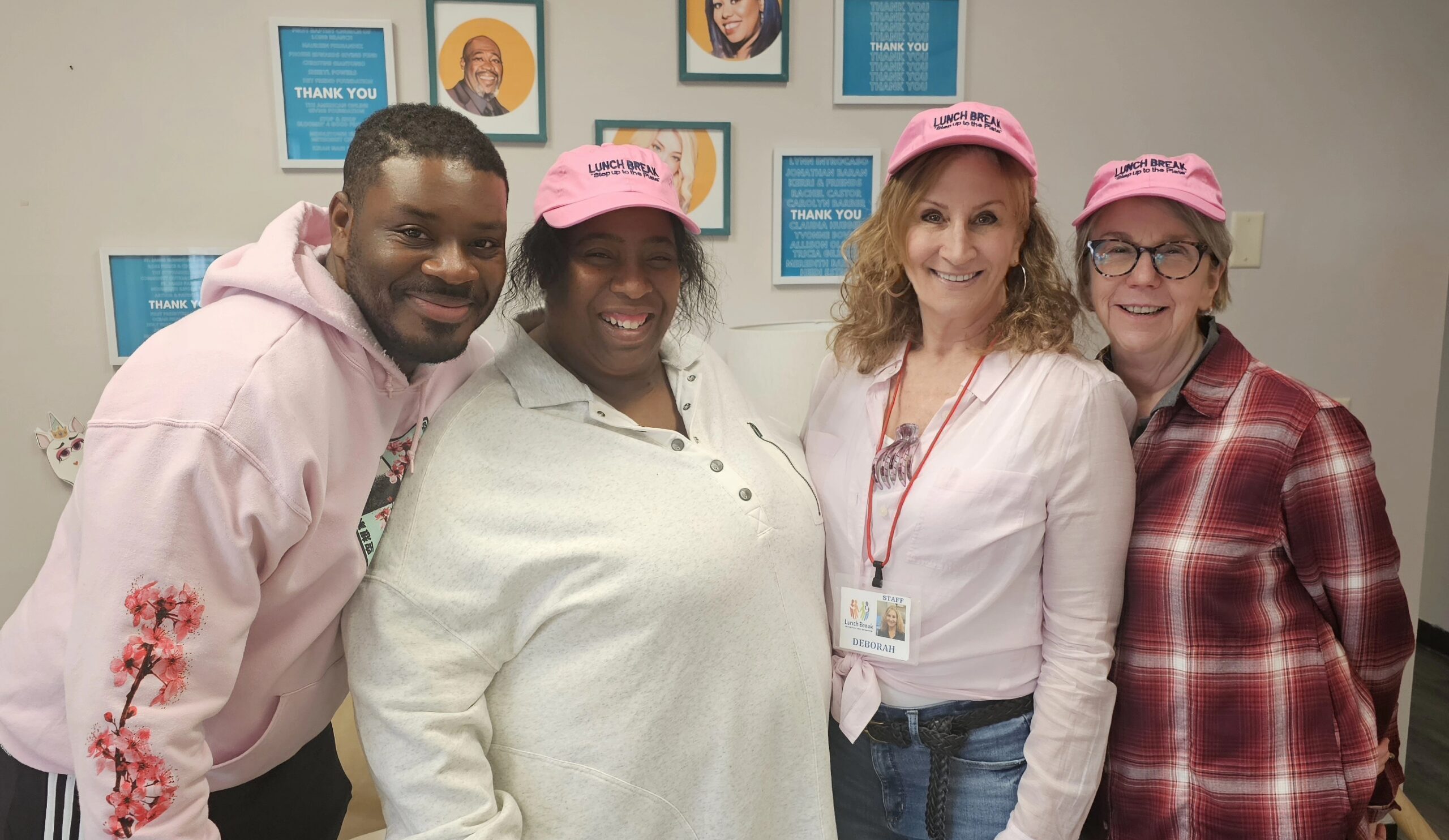 Group of people wearing pink Lunch break hats