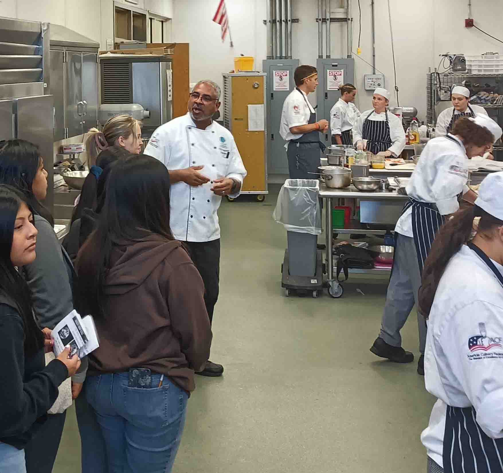 A group of people touring the lunch break kitchen