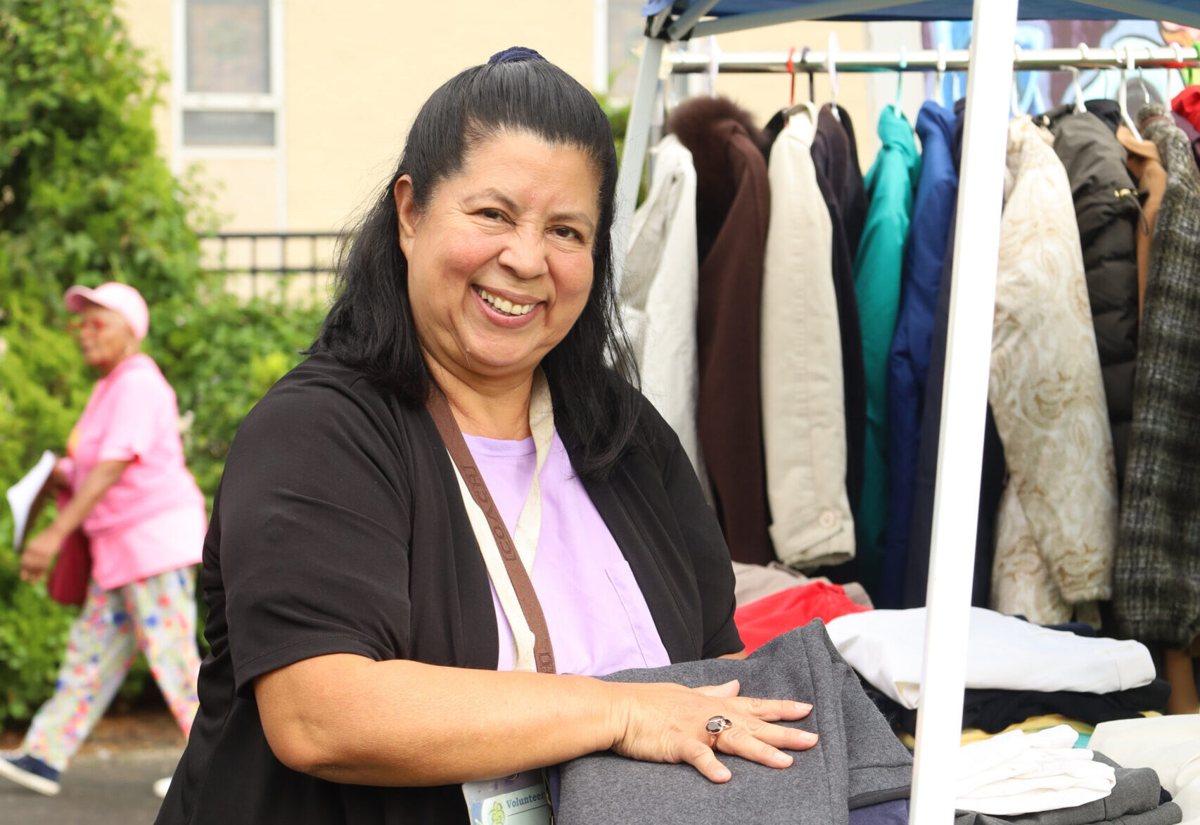 Woman smiling while folding clothes
