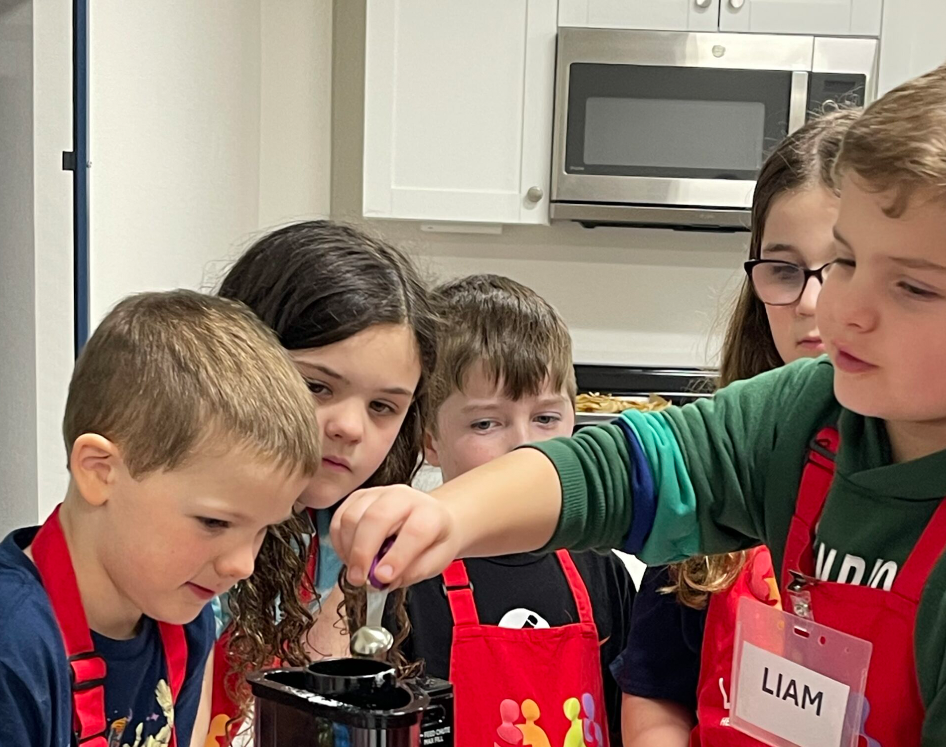 Group of kids cooking in the kids cooking class