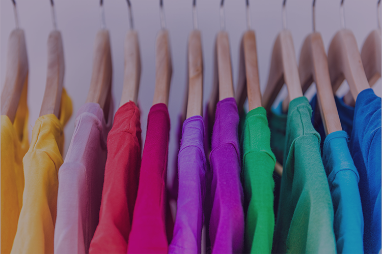 Colorful shirts hanging up in a closet