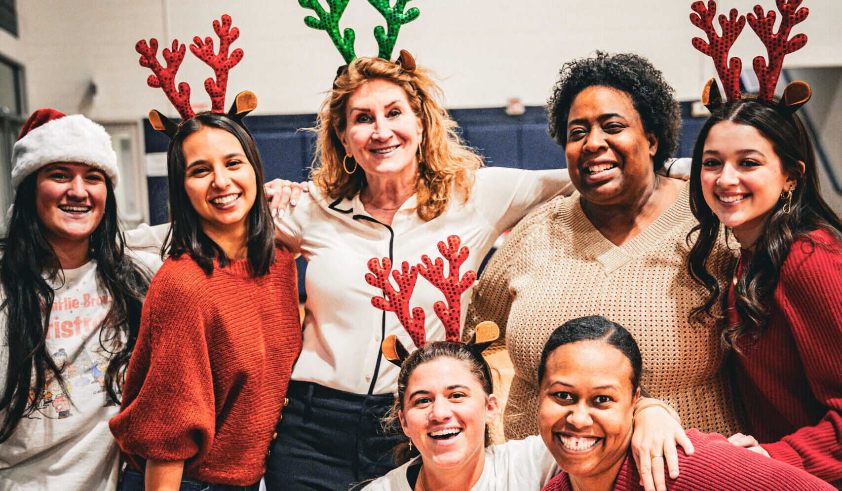 Group of people wearing antlers for a christmas party