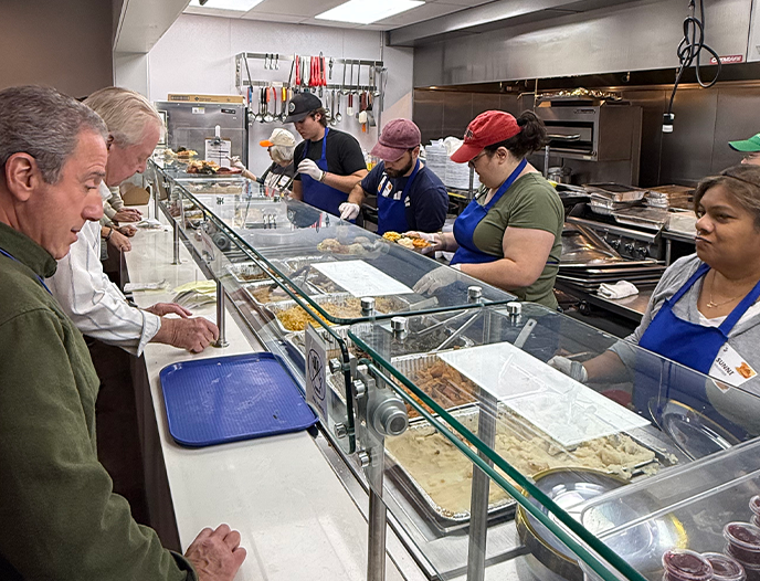 People serving food on a service line