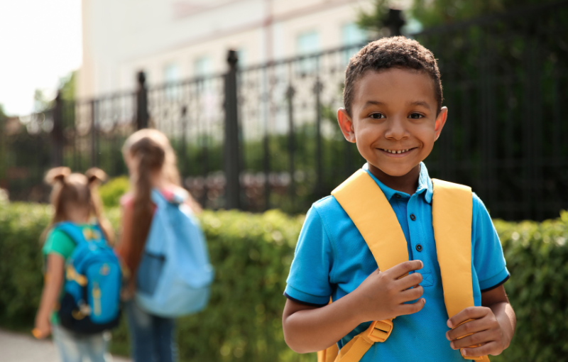 smiling child wearing a backpack